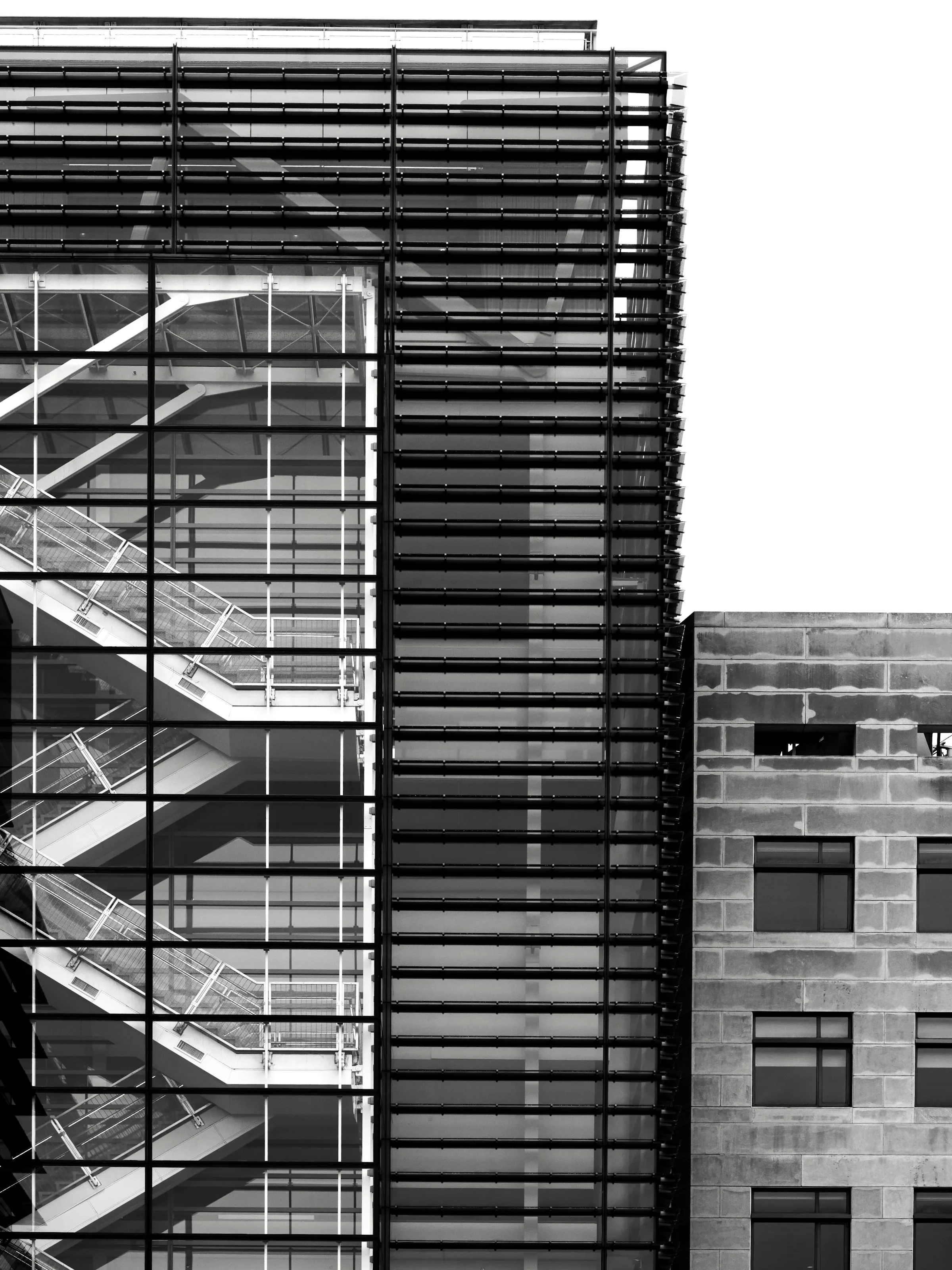Glass office staircase symbolizing structured, real-world IT talent vetting